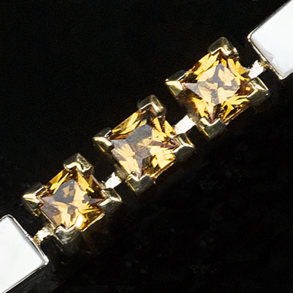 Gemstone resting in the maker&rsquo;s hand, examined for color and character